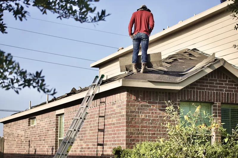 Professional roofer working on a residential roof in Wichita